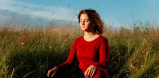 Both Ayurveda As Well As Allopathy Are Needed In A Country Like India Woman Sitting in a field