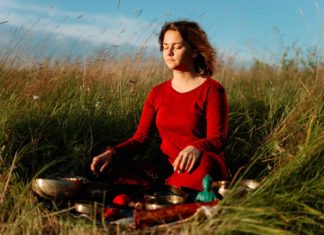 Both Ayurveda As Well As Allopathy Are Needed In A Country Like India Woman Sitting in a field