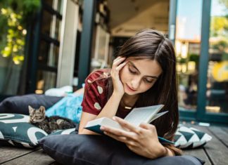 List Of Must Read Books That No Book Lover Can Afford Missing Out | N4M Review Young Book Lover Enjoying a Must Read Book