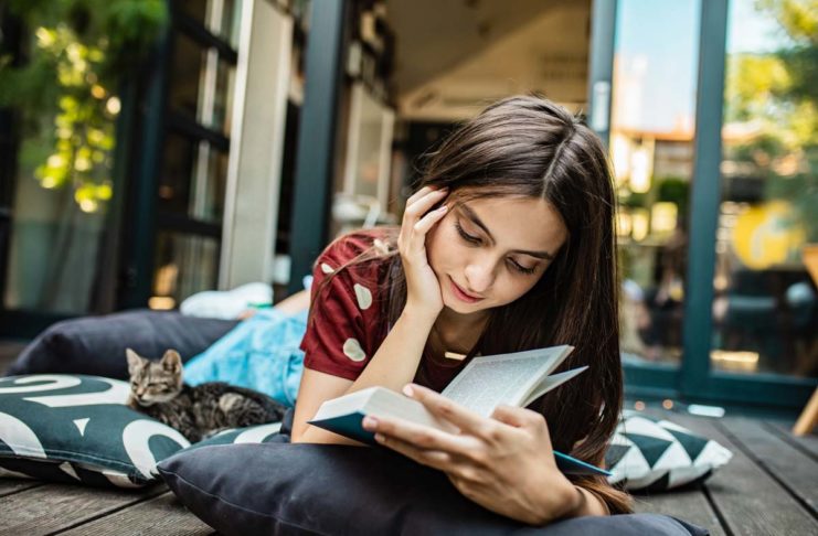 Young Book Lover Enjoying a Must Read Book