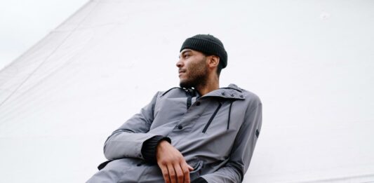 The Ideal Fashion Statement: How To Pair Beanie With Denim To Get The Stylish Look Man posing stylishly