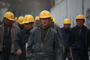 Workers wearing yellow helmets