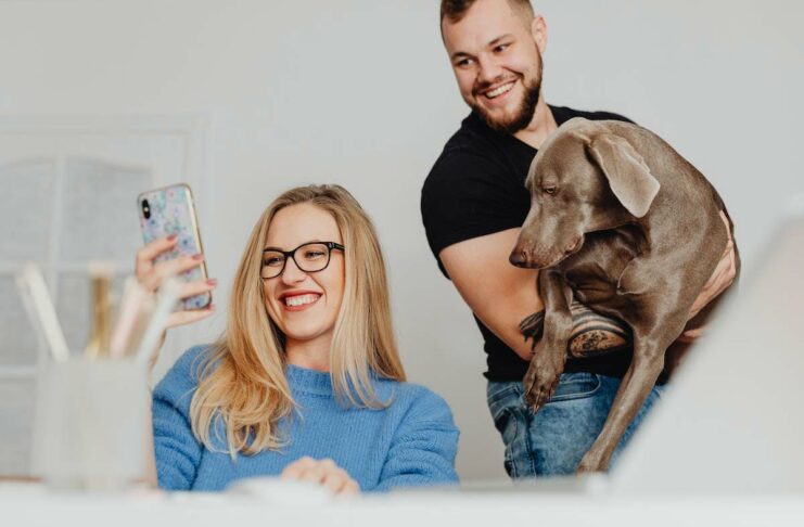 Woman selfies with husband and pet